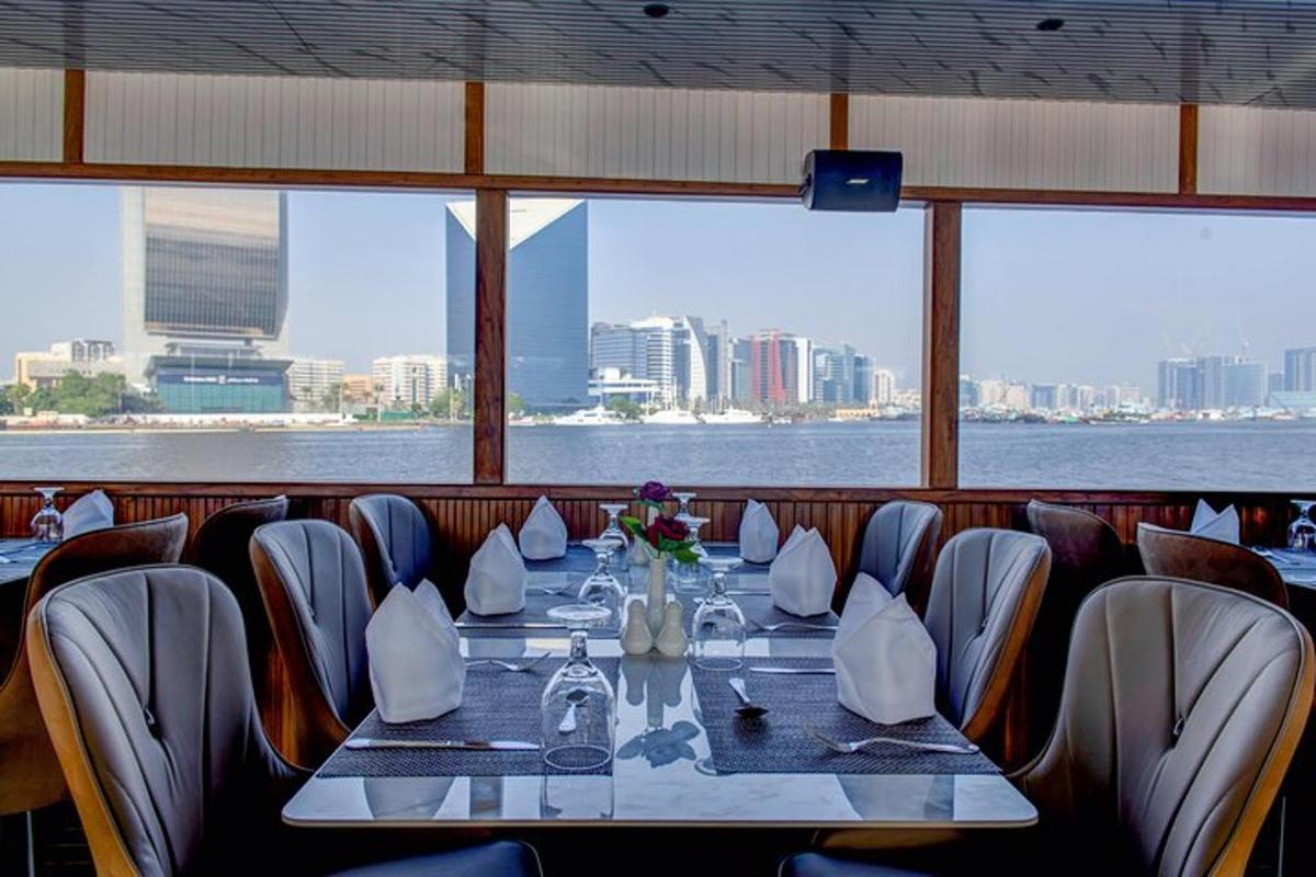 Luxury dinner cruise dubai marina yacht sailing through Dubai Marina skyline at sunset